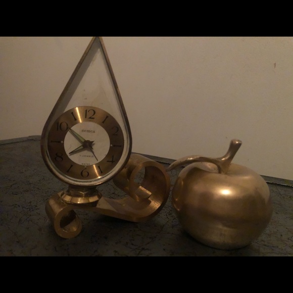 Brass clock and apple